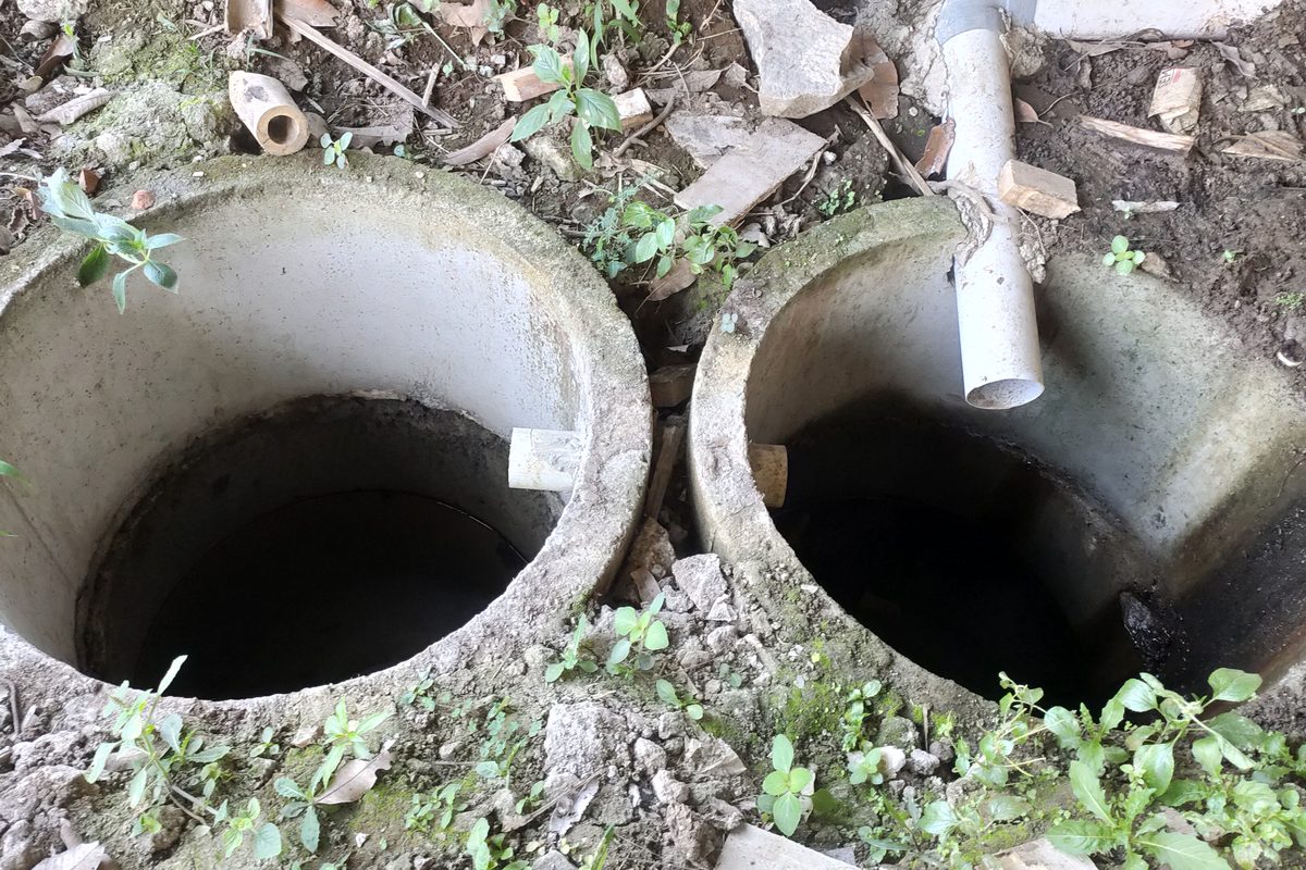 Two infiltration well rings set in the ground side by side